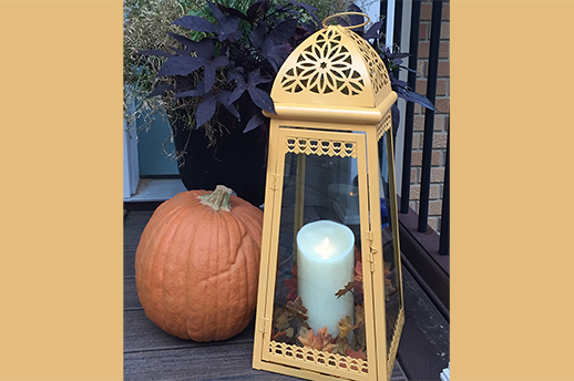 Painted metal lantern and candle